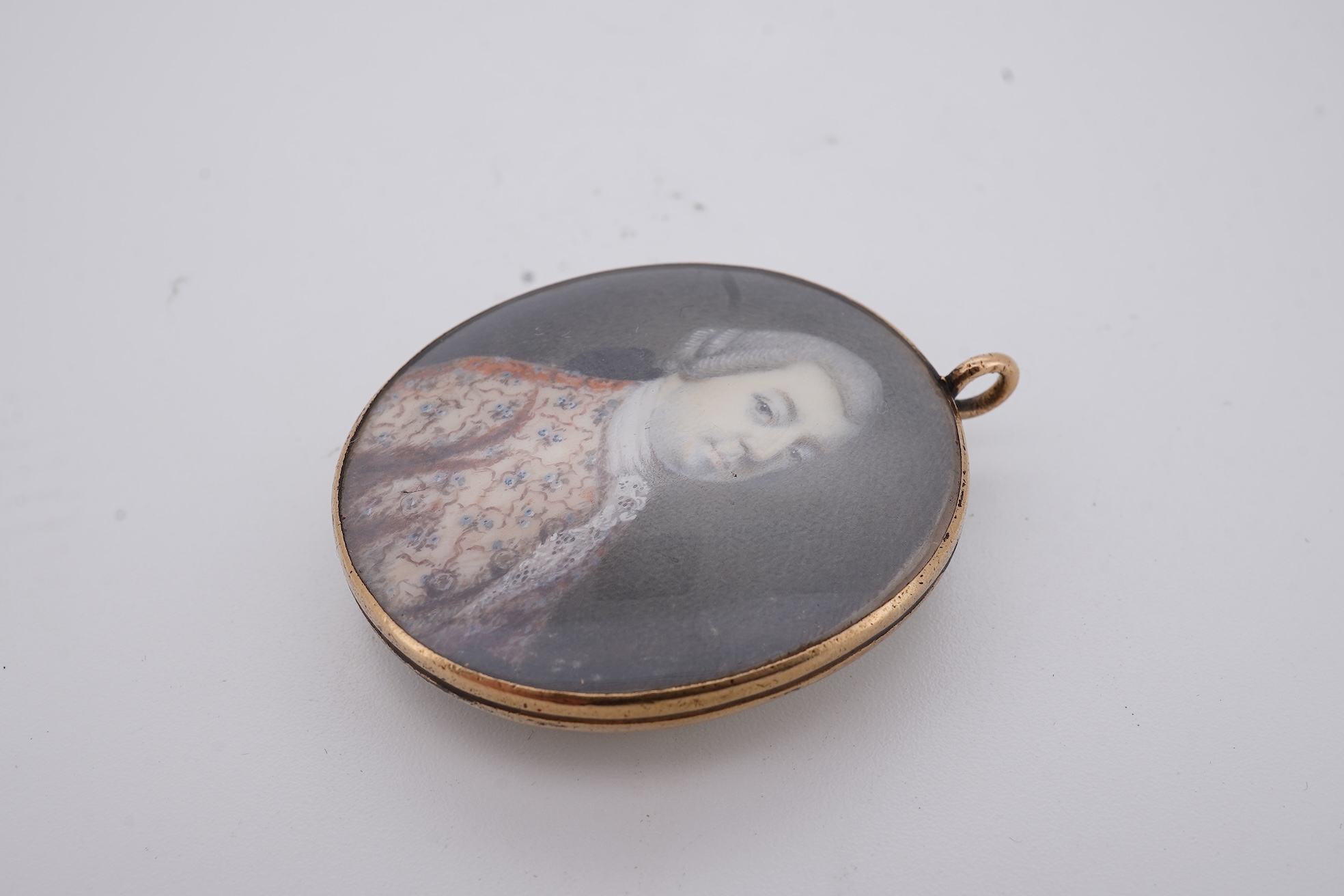 A 19th century gilt framed oval miniature watercolour portrait of a gentleman, on ivory, verso decorated with hair, depicting a landscape scene with a large tree, animals and a house, 36mm. CITES Submission reference, WU